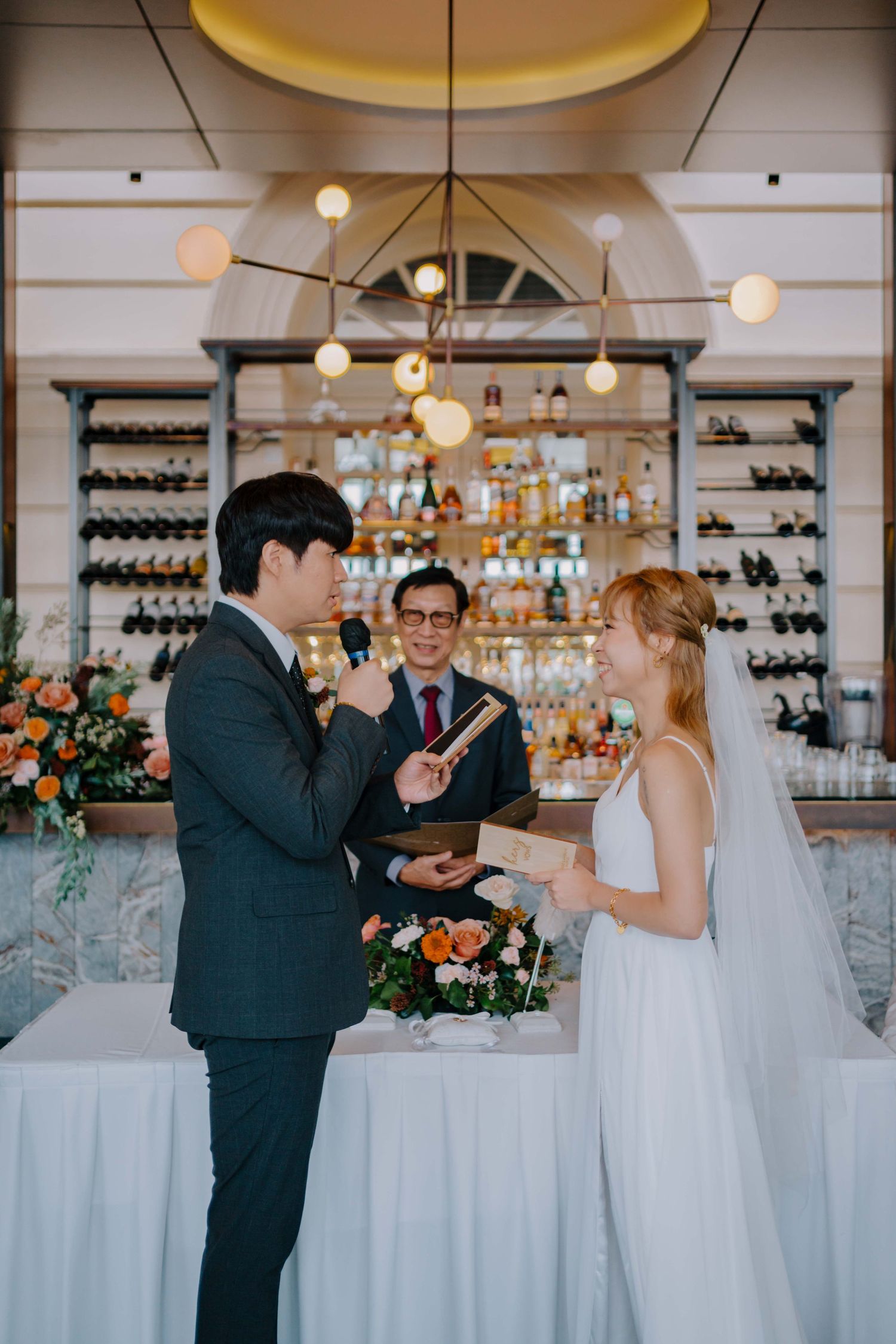 bride and groom read vows to each other at empress restaurant singapore