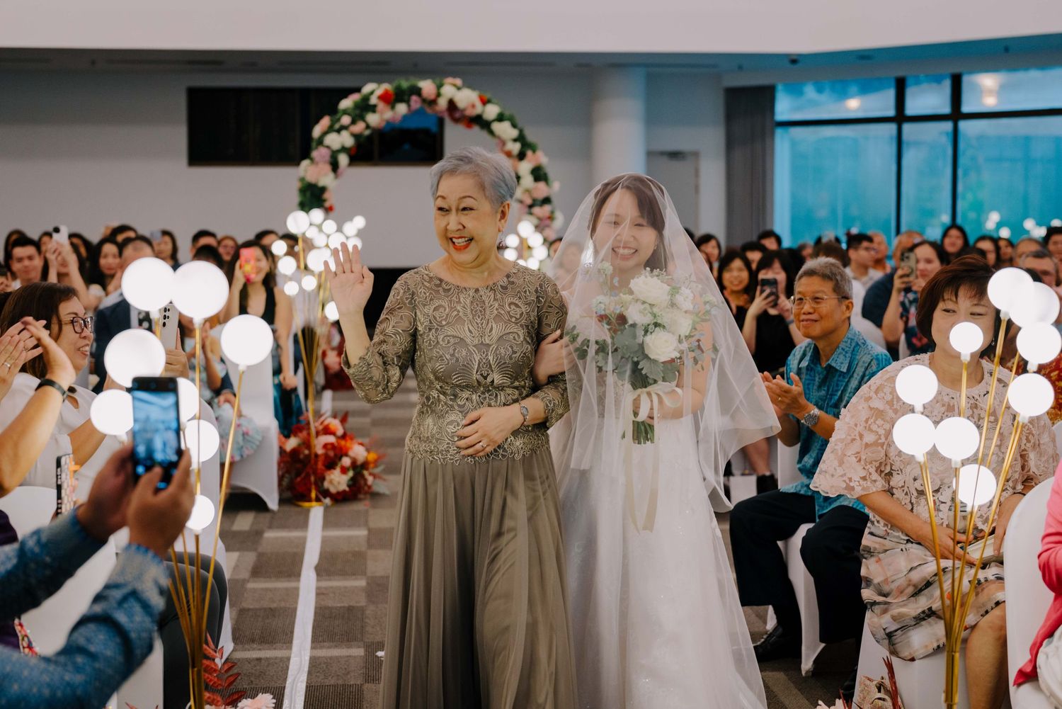 bride and her mother walking down the aisle