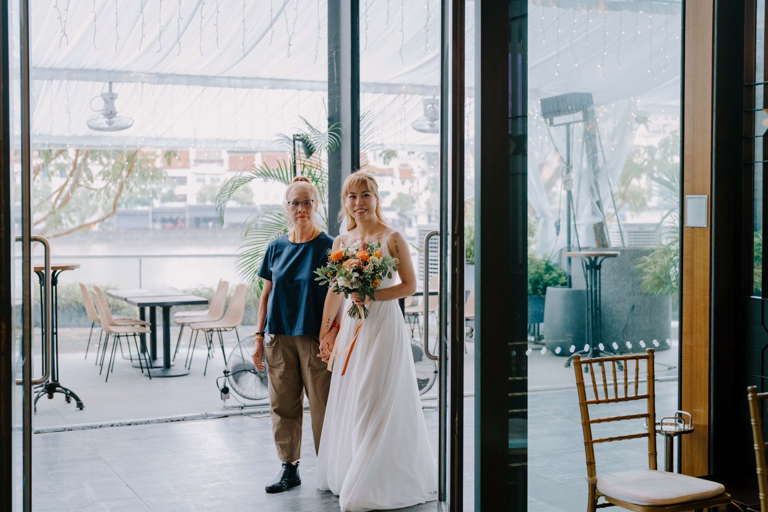 bride and her mother walks down the aisle