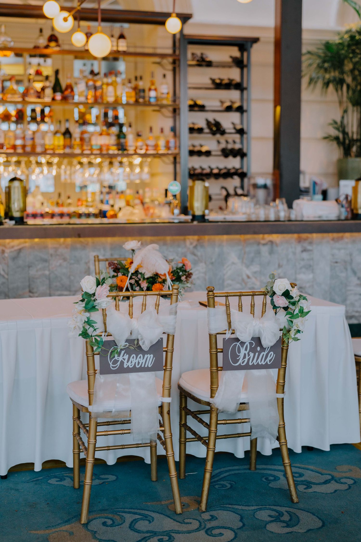 bride and groom chairs decorated for a wedding at acm empress