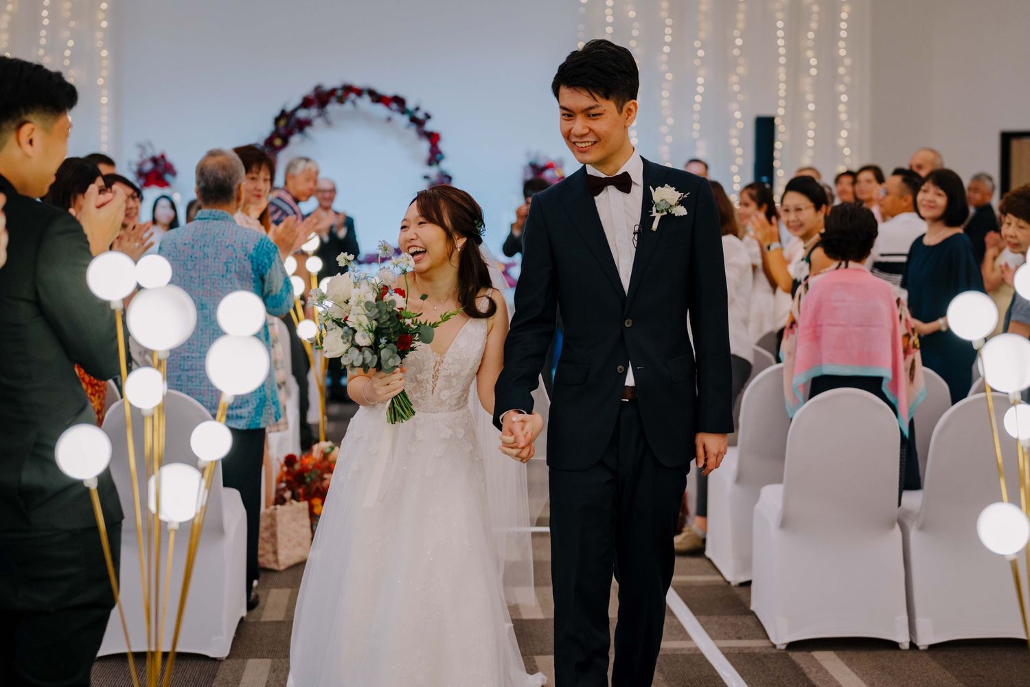 bride and groom marches out as newlyweds