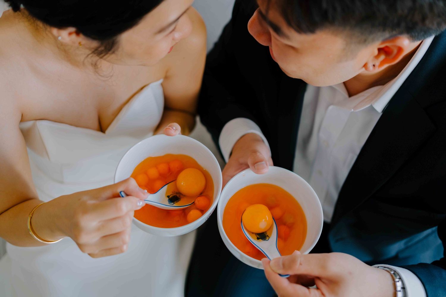 bride and groom eating tangyuan on their wedding day