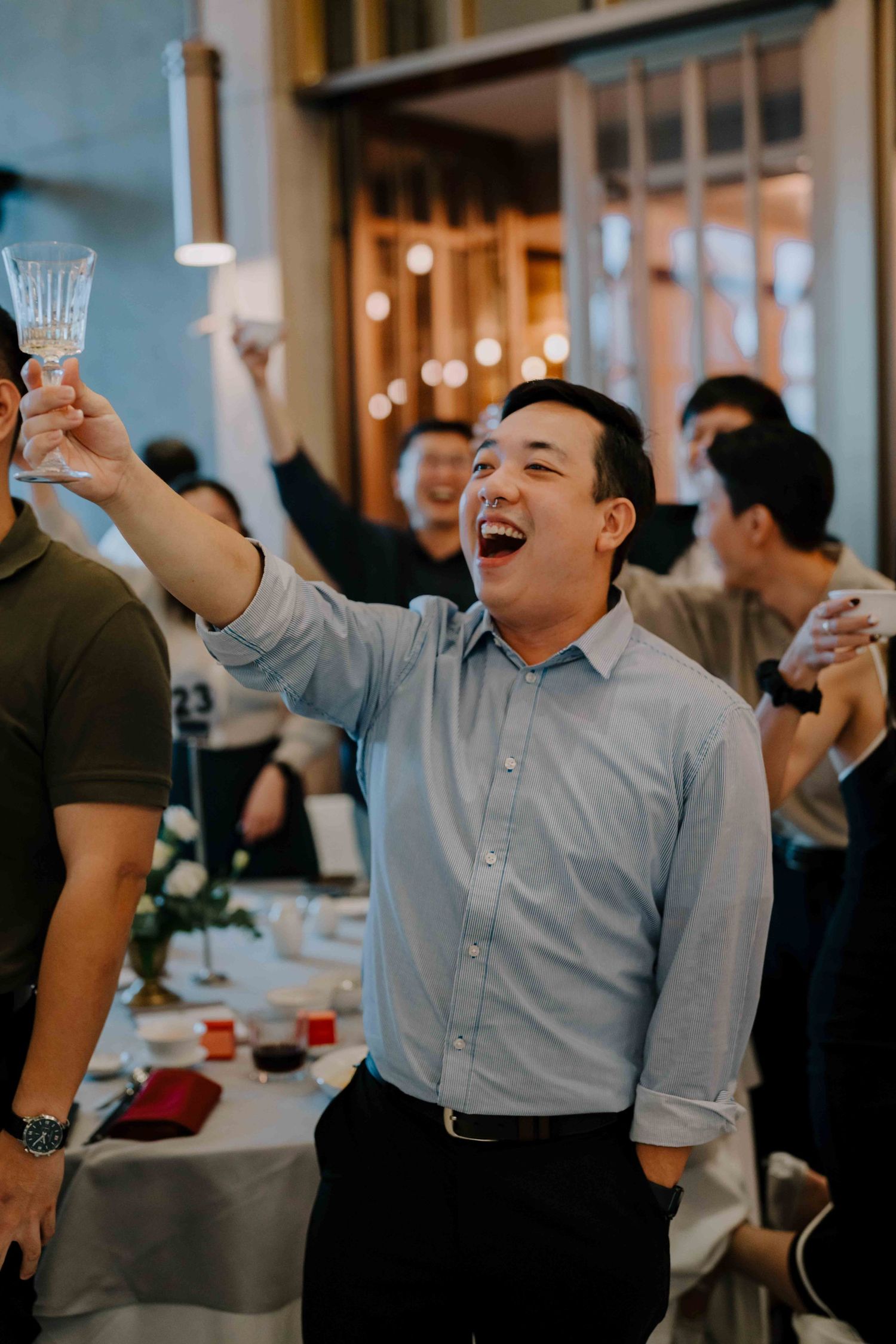 wedding guest toasting to the newlywed couple at andaz hotel glasshouse