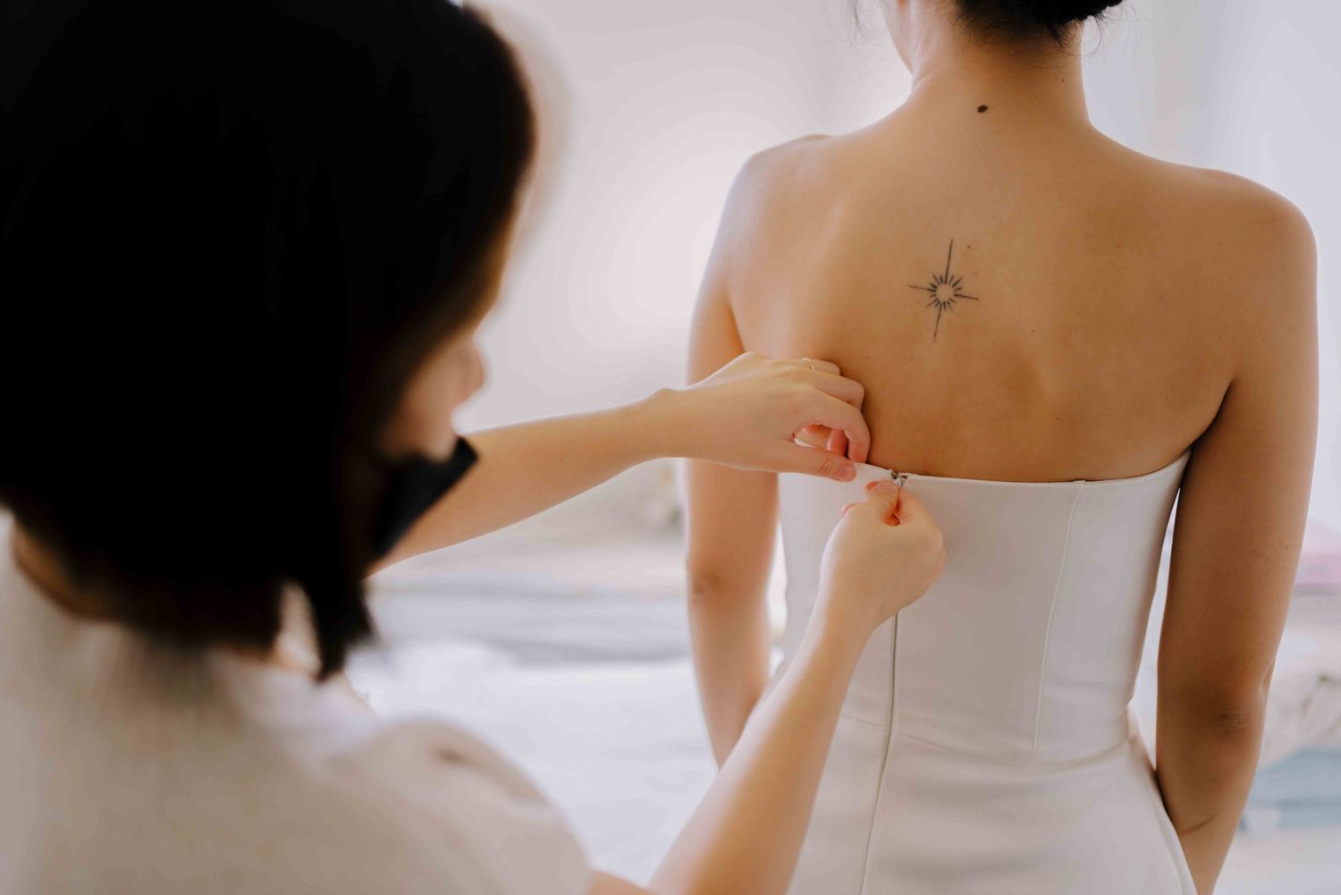 wedding gown on a bride with back tattoo