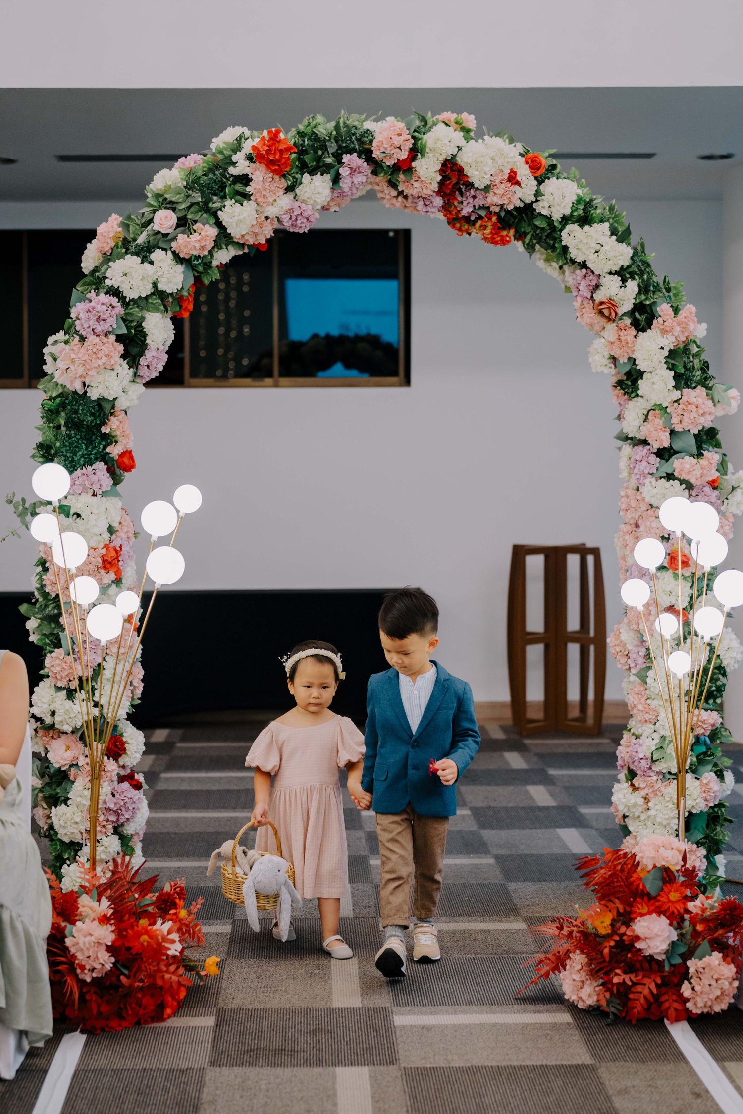 flower girl and paige boy holding hands down the aisle