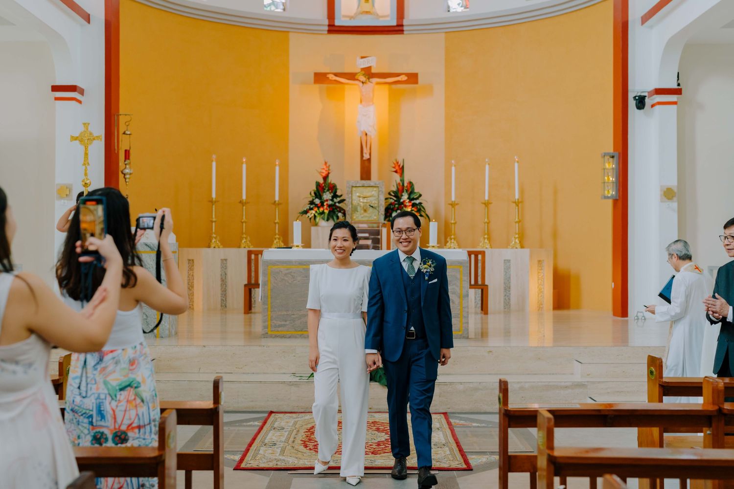bride and groom march out as a newlywed couple