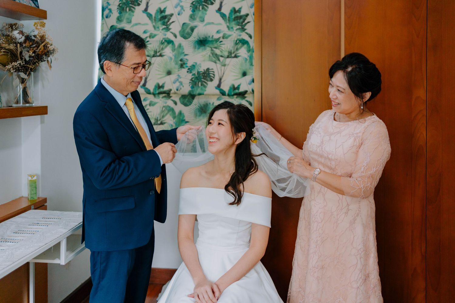 bride's parents put on veil for bride