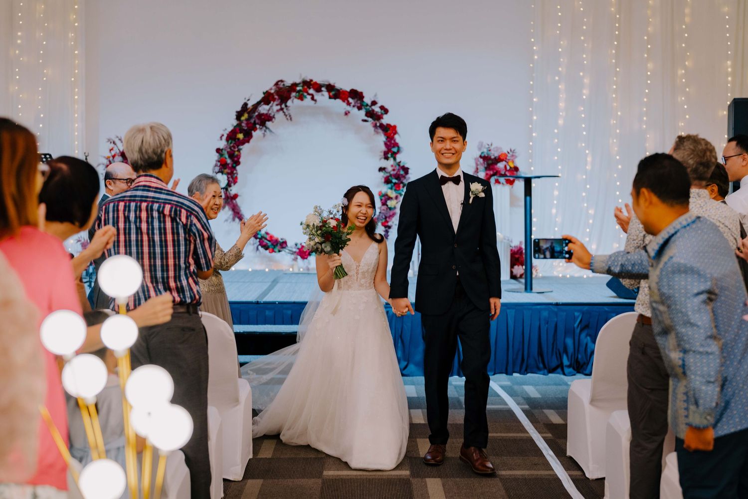 bride and groom marches out as newlyweds