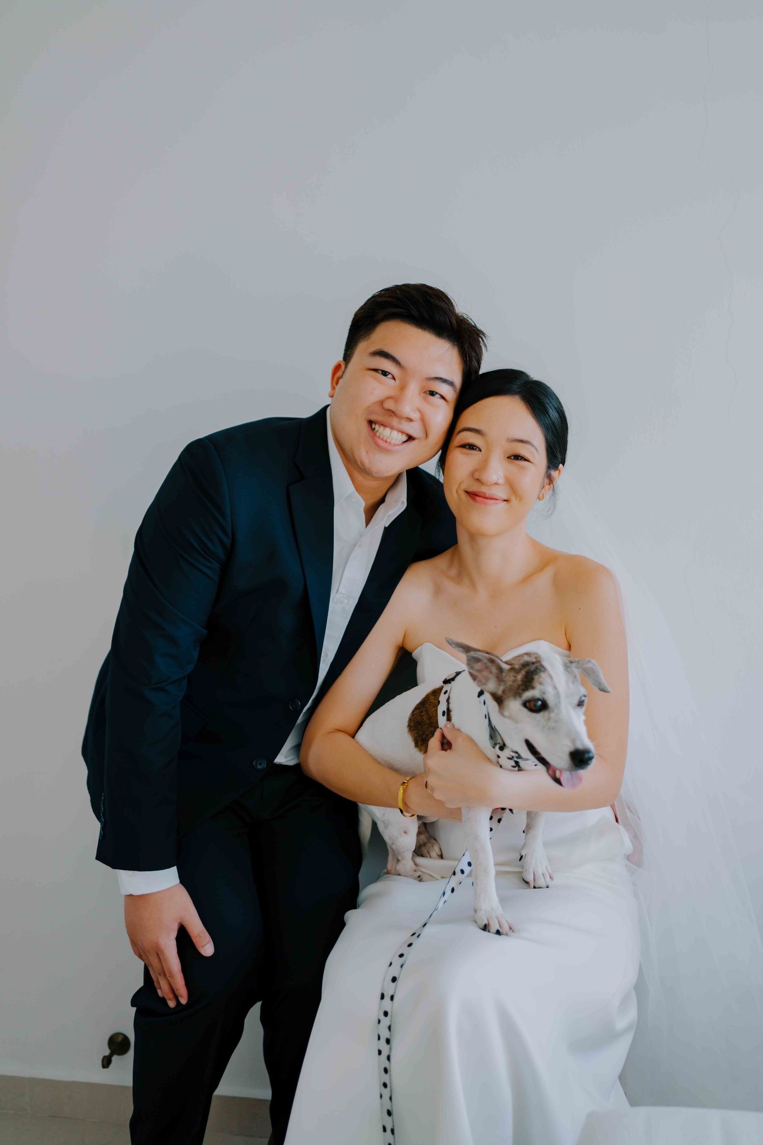 portrait of bride and groom and their pet dog