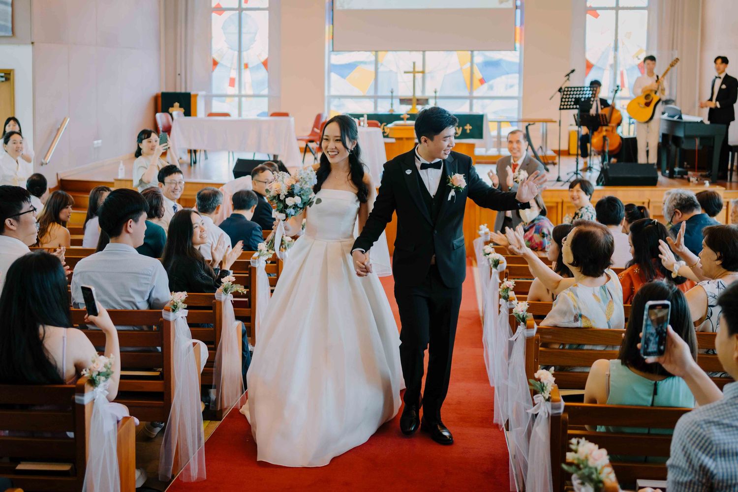 bride and groom march out as newlyweds at lutheran church of our redeemer singapore