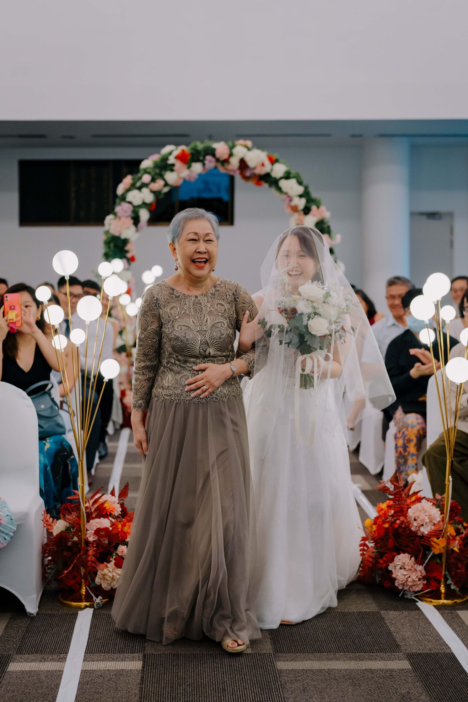 bride and her mother walking down the aisle
