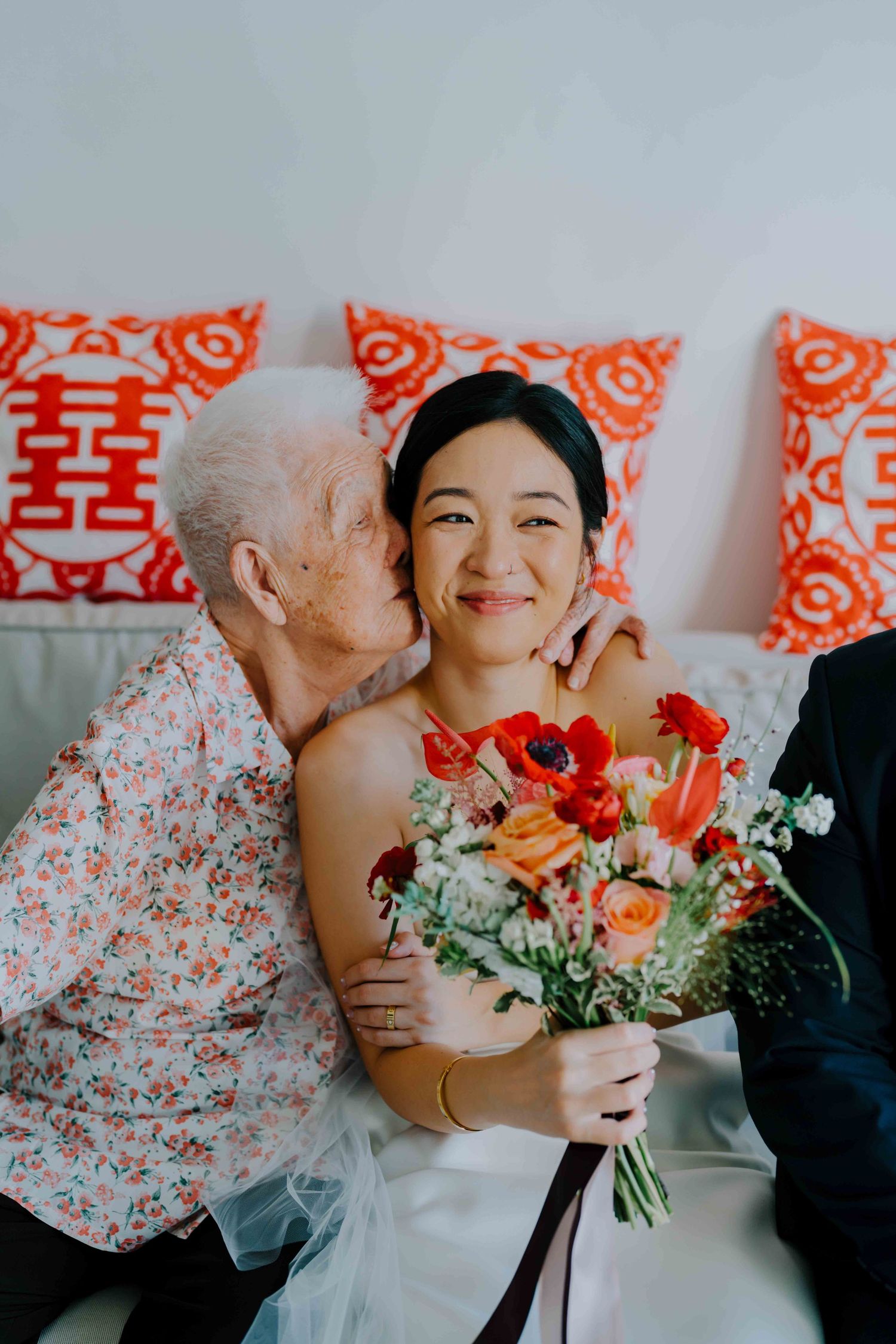 grandmother of bride gives her a kiss on the cheek