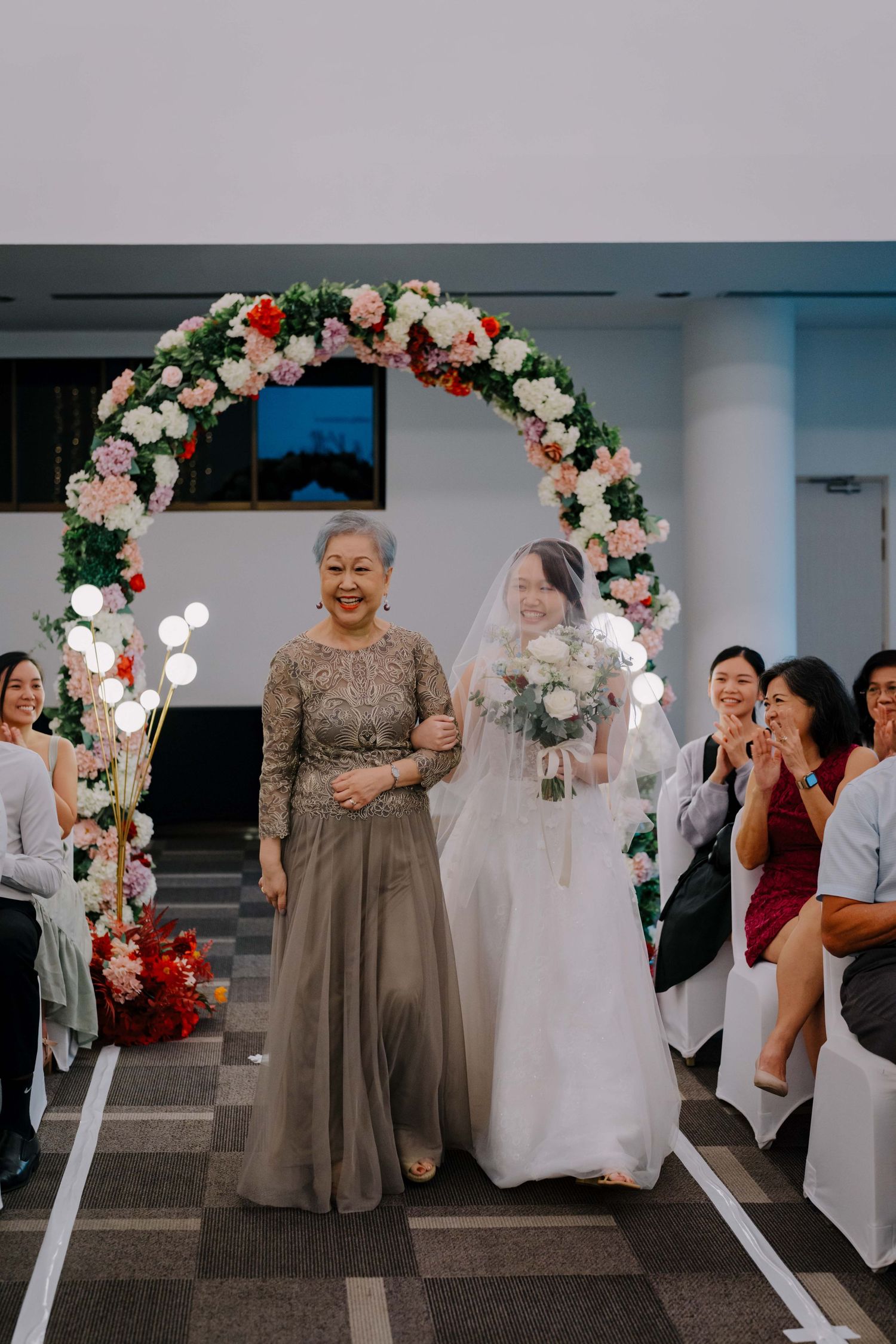 bride and her mother walking down the aisle