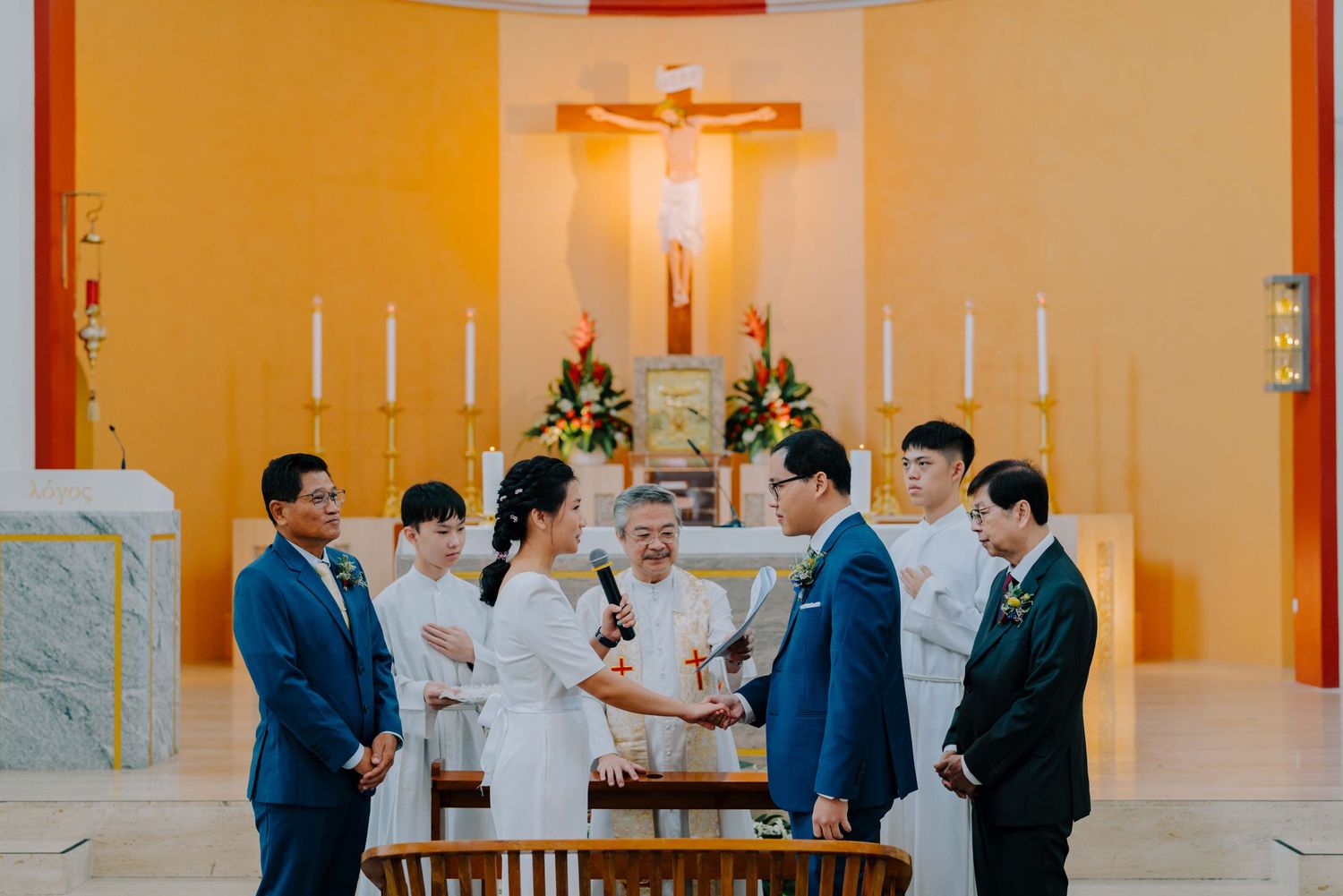 wedding couple reading vows at a holy matrimony service in catholic church in singapore