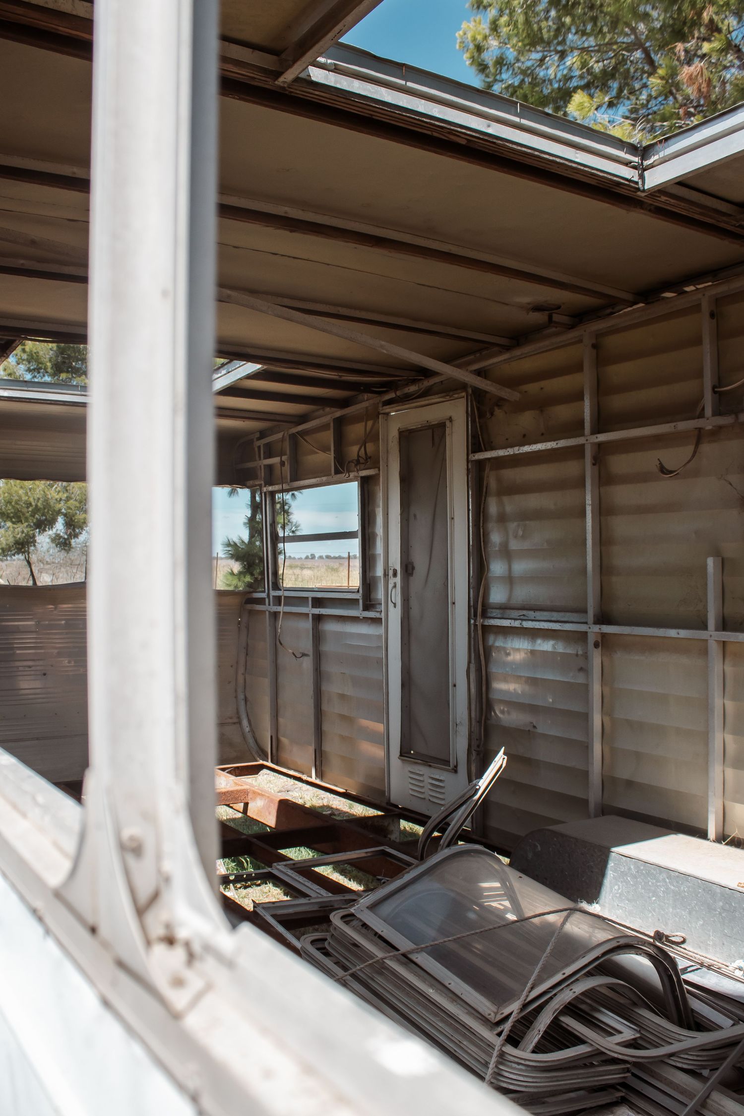 Multiple window frames in a row showing deteriorating window seals and weathered aluminum framing on a building exterior.