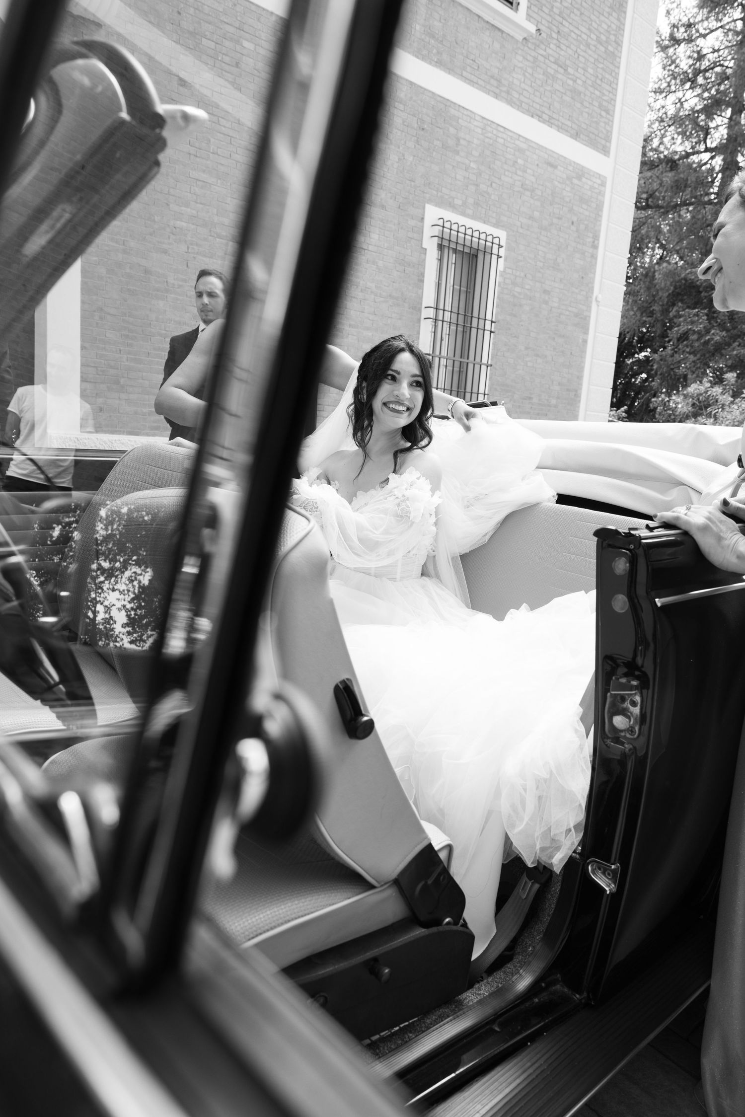 Black and white photos capture a bride entering a classic car.