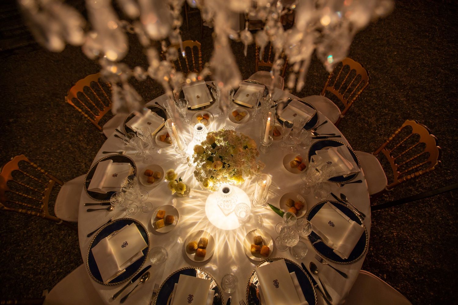 Ornate table centerpieces with glowing candles creating romantic ambiance at wedding reception.