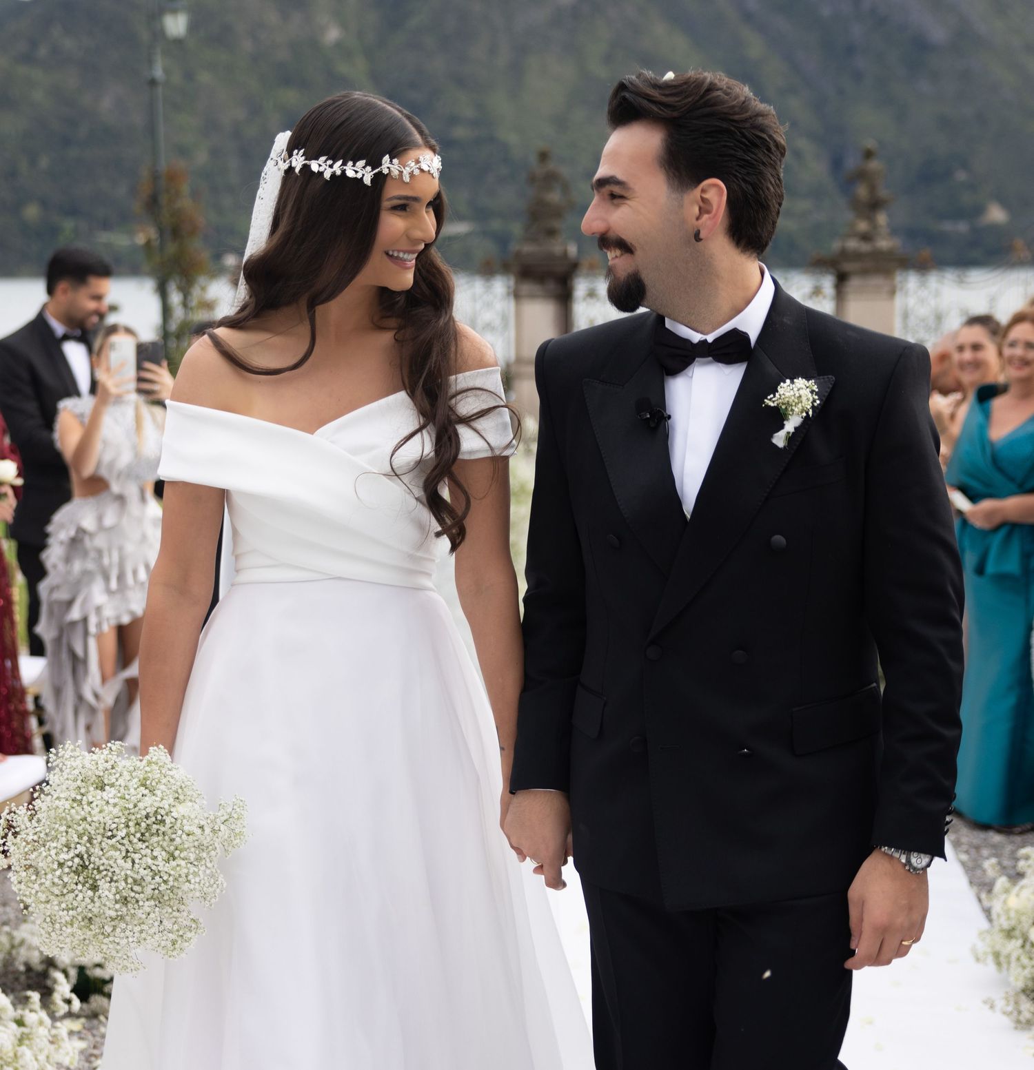 Elegant wedding ceremony with scenic mountain backdrop and guests in attendance.