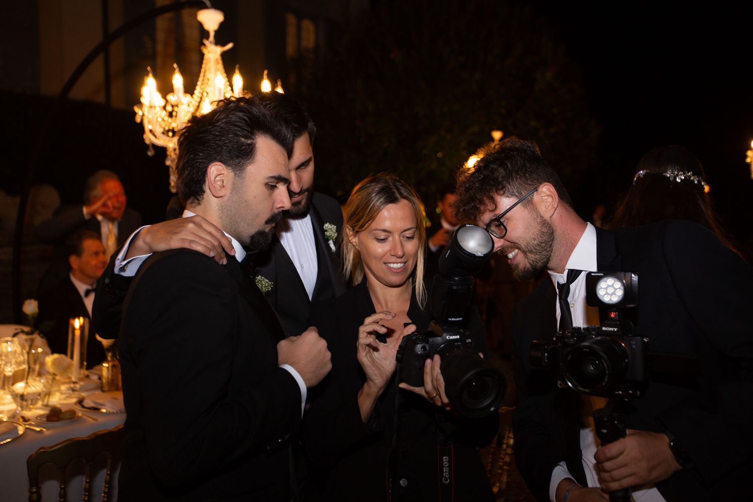 Guests dancing and celebrating at an elegant candlelit wedding reception.