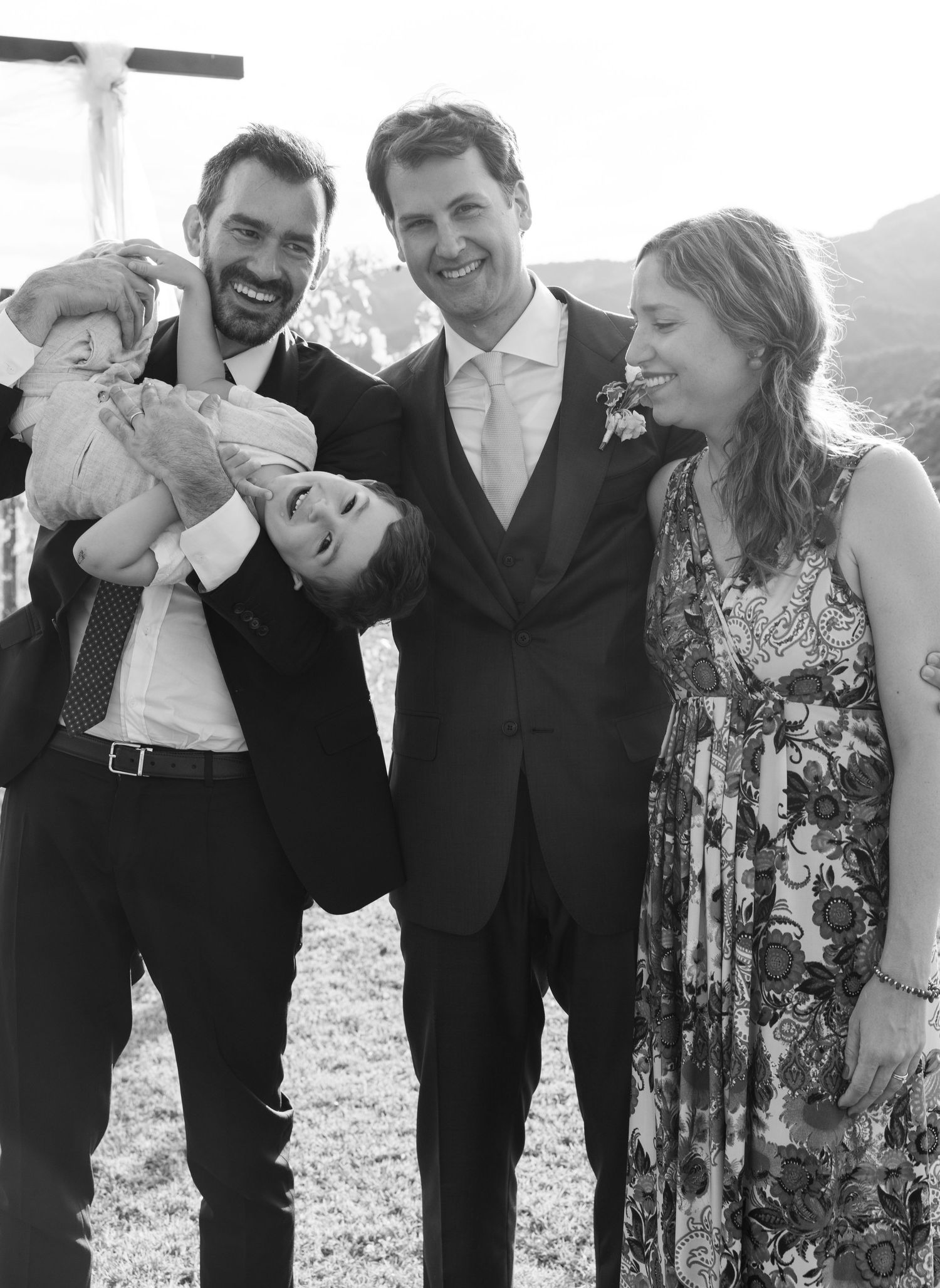 A group of wedding guests sharing laughter and joy during outdoor celebrations.