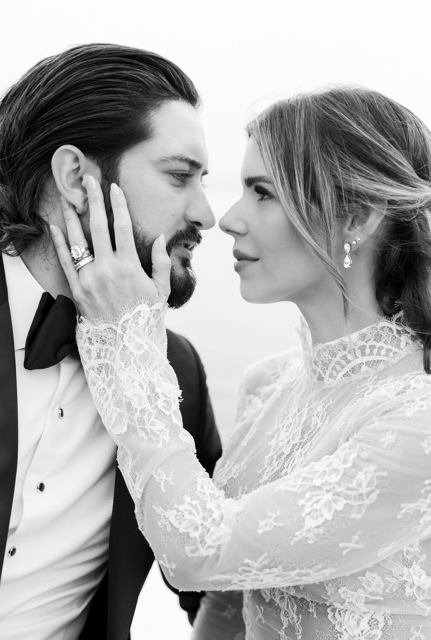 A romantic black and white photo series showing a couple in wedding attire sharing intimate moments.