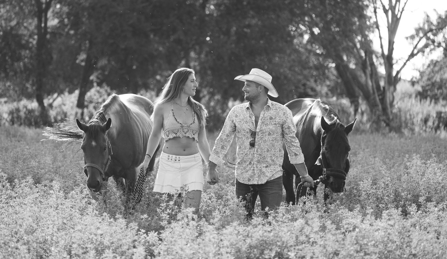People walking together through a sunny meadow on a summer day.
