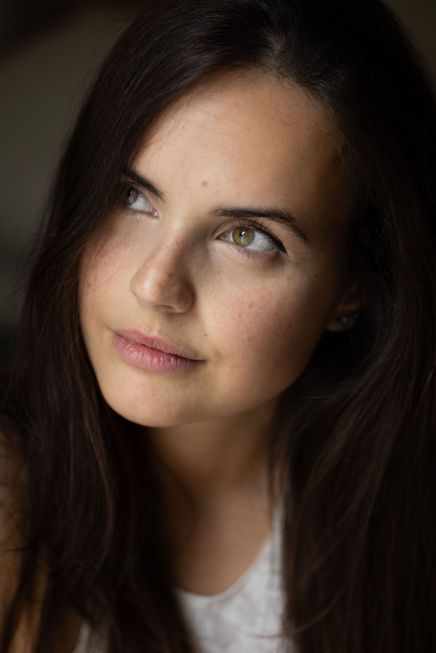 Artistic portrait series showing different angles in dramatic lighting.