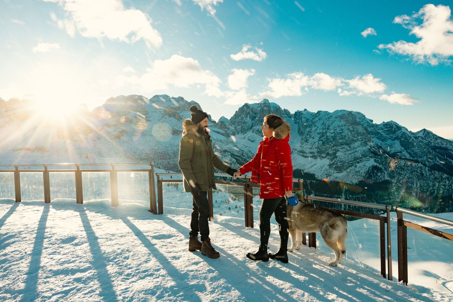 Winter sports enthusiasts enjoying panoramic mountain views at a snow-covered ski resort.
