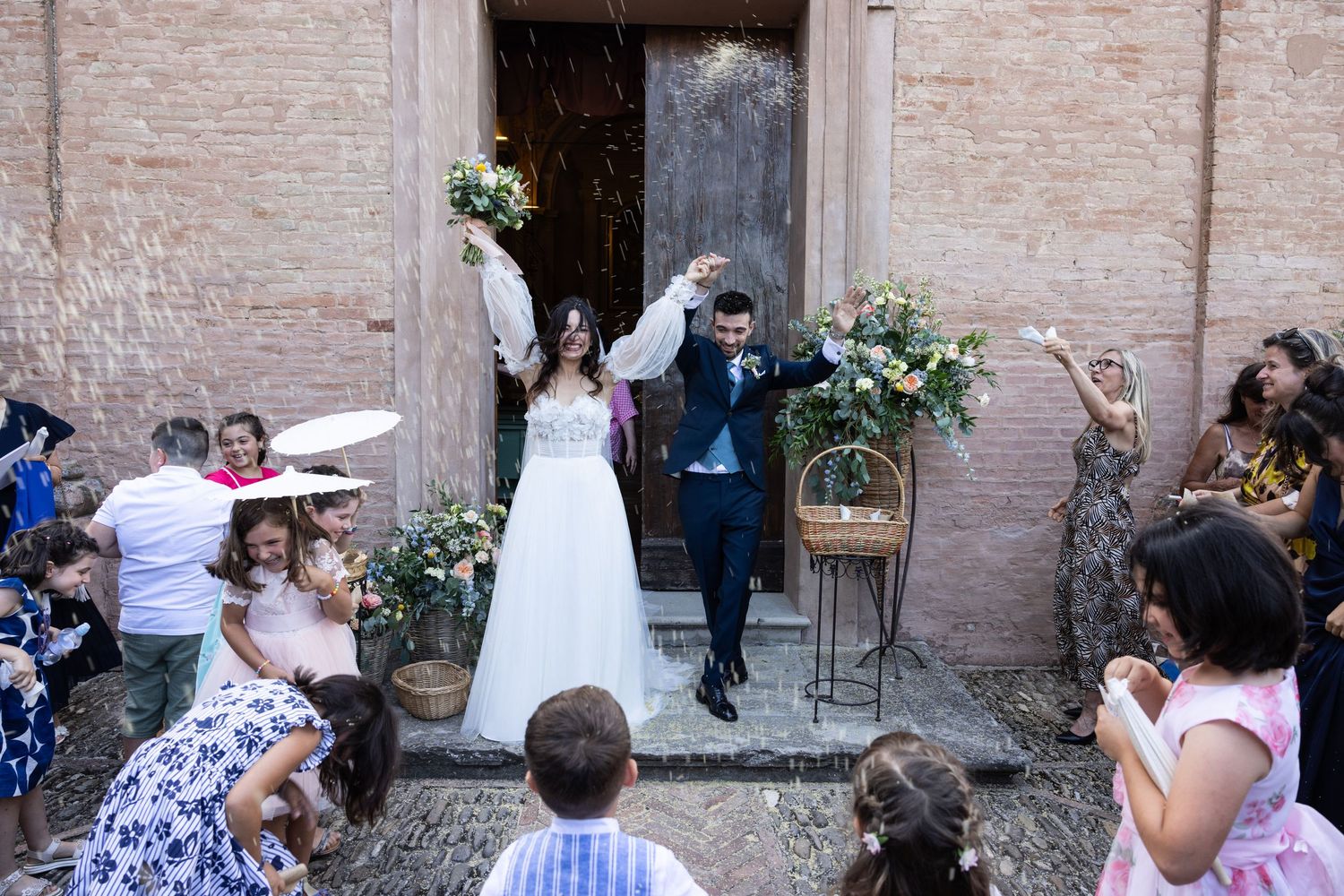 Wedding celebration in a charming outdoor venue with exposed brick walls and natural lighting.