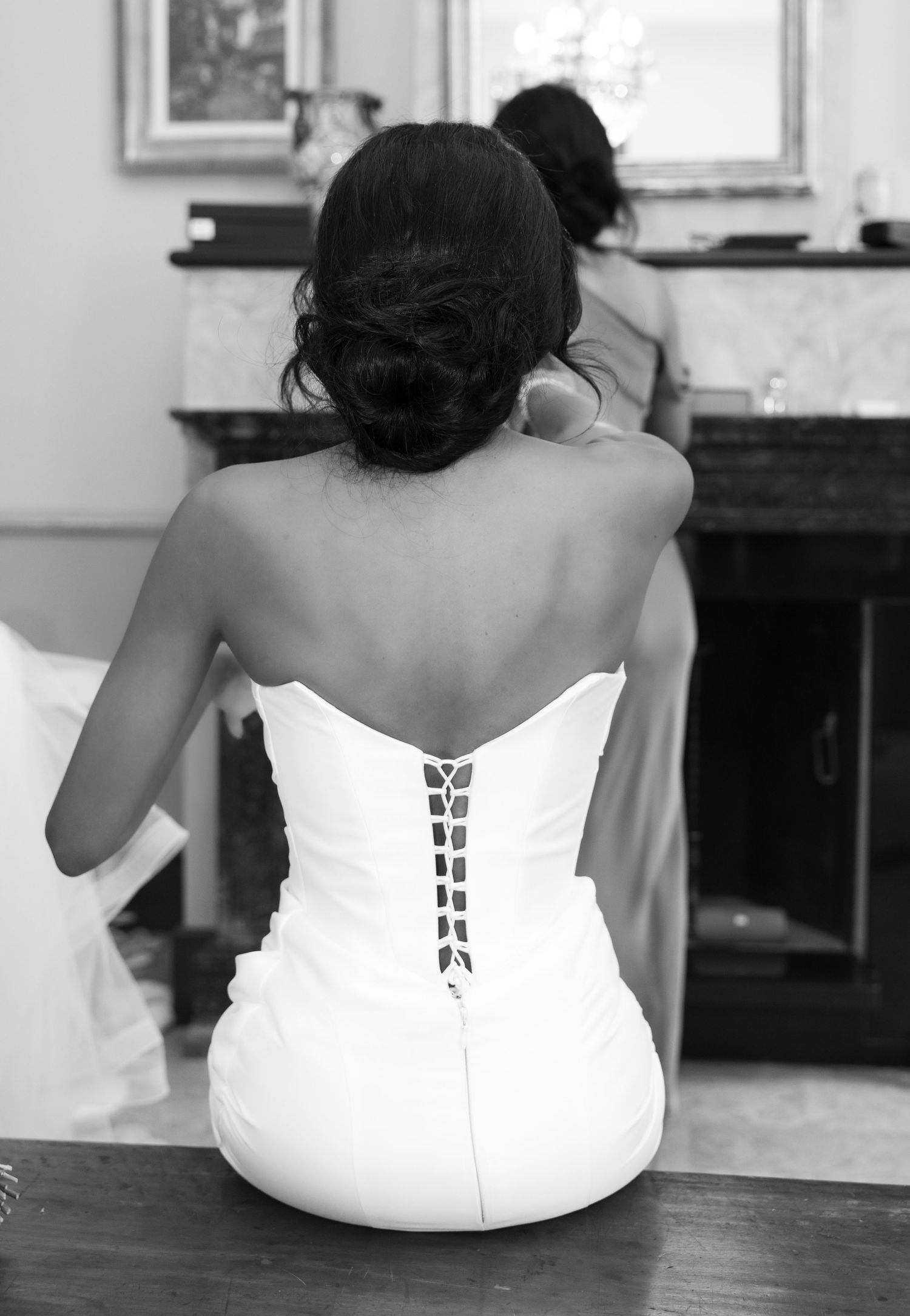 Black and white photo series showing back view of person in white dress sitting on wooden bench.