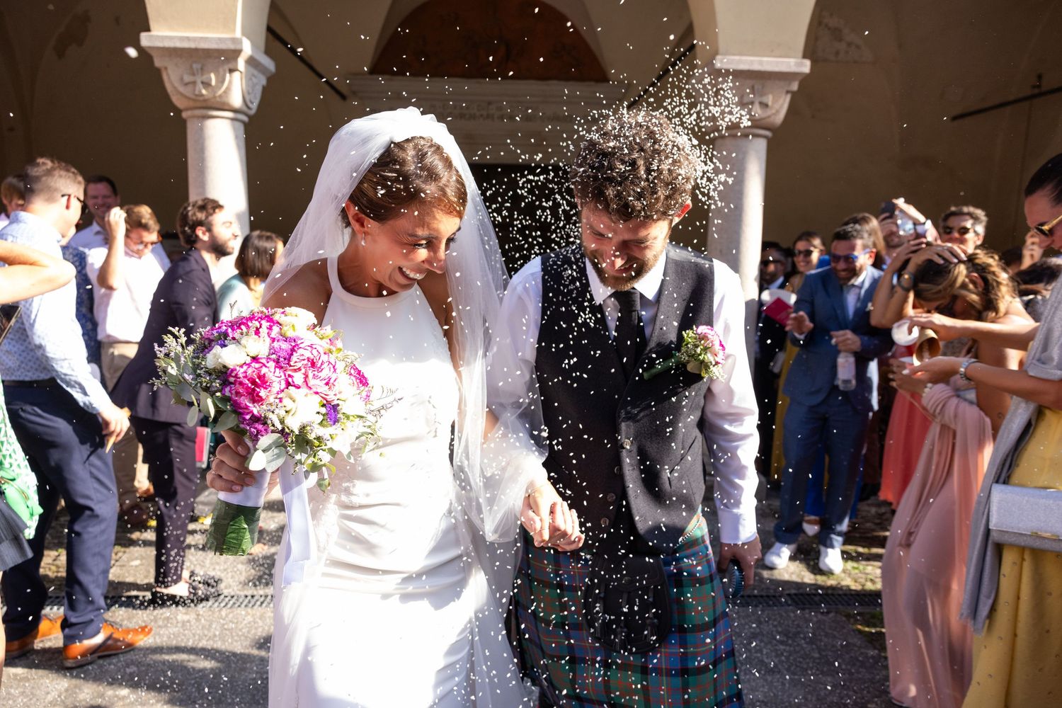 Wedding celebration sequence showing guests throwing confetti outside a church.