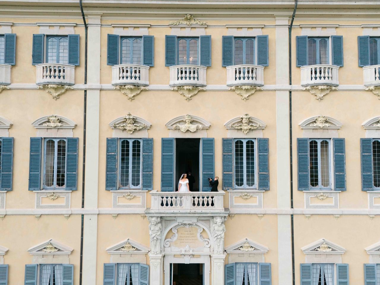 Elegant Italian villa facade with blue shuttered windows and ornate balconies.
Villa Sola Cabiati