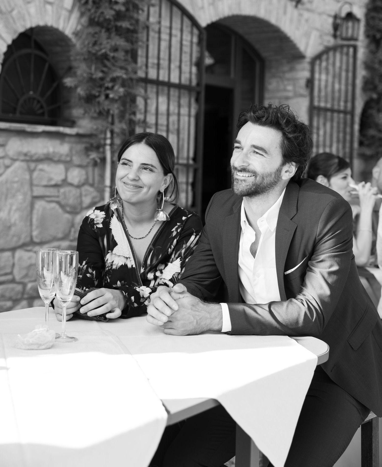 Black and white candid reception photos showing laughter and joy at a wedding celebration.