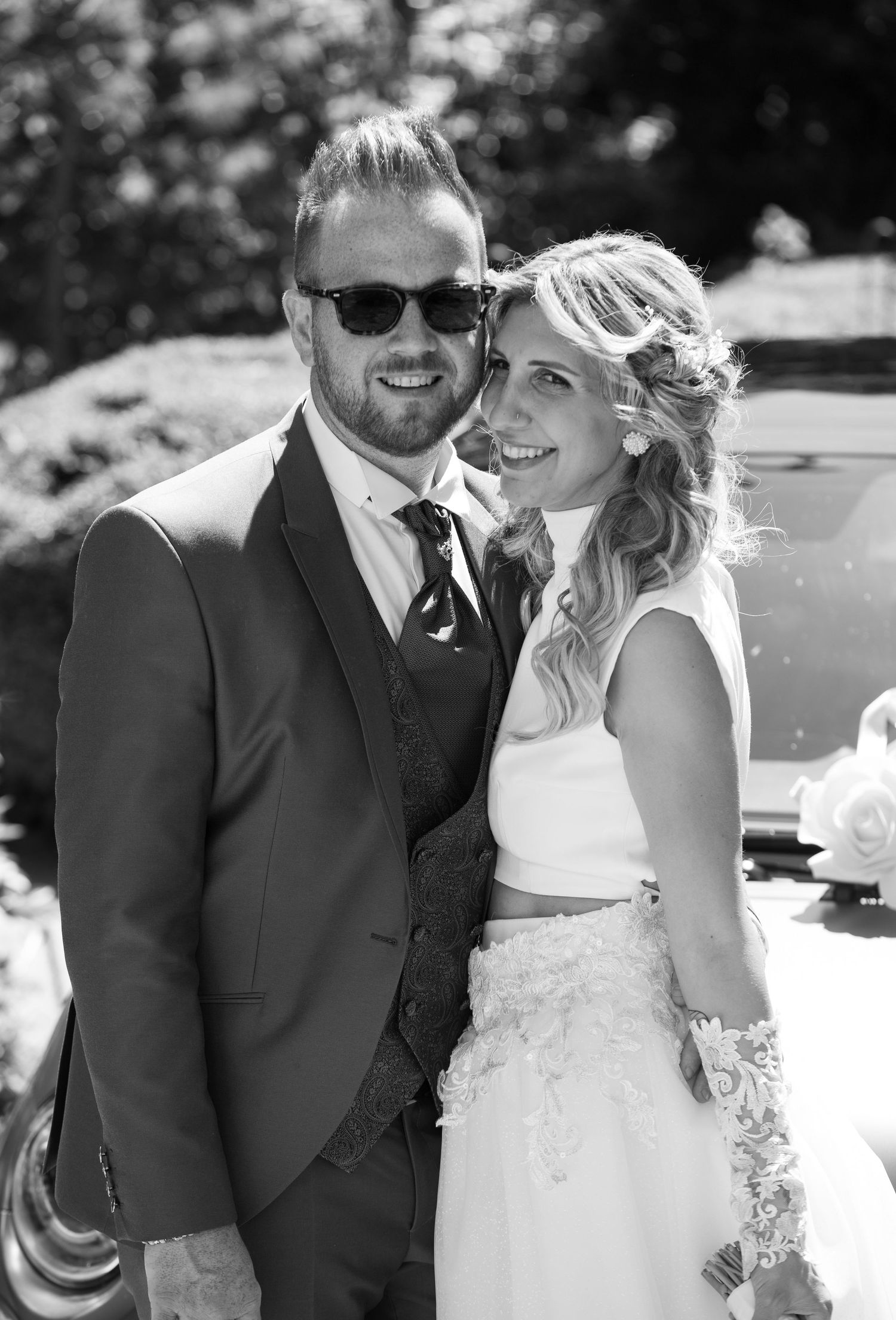 Black and white wedding portraits showing joyful moments in bright sunlight.