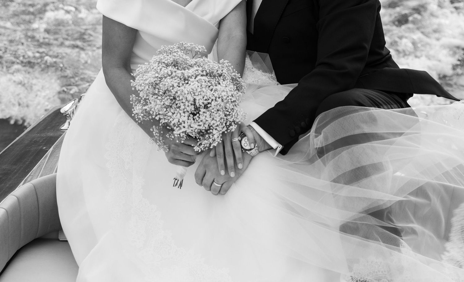 Close-up details of lace wedding dress and floral bouquet arrangements.