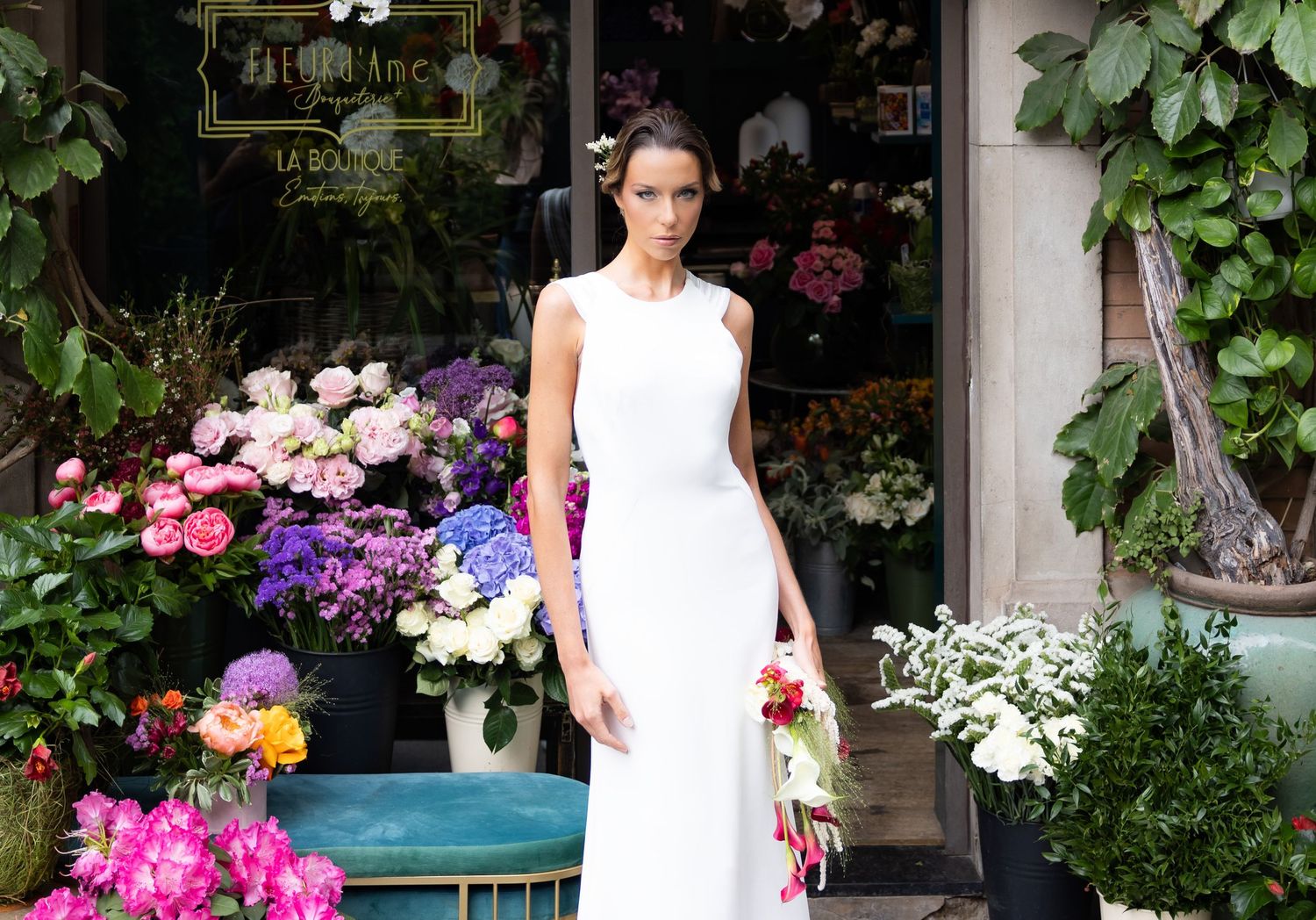Bridal photography session outside a charming boutique adorned with colorful flowers.