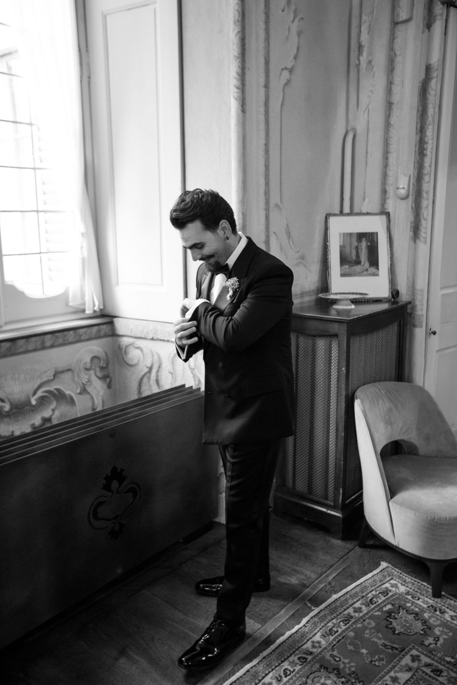 Professional photographer working in a vintage room with natural window light.