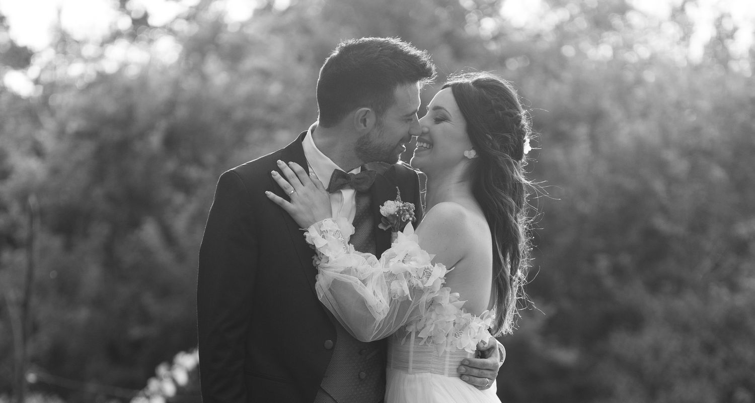 Black and white photo of a couple sharing a tender moment during their wedding photoshoot.