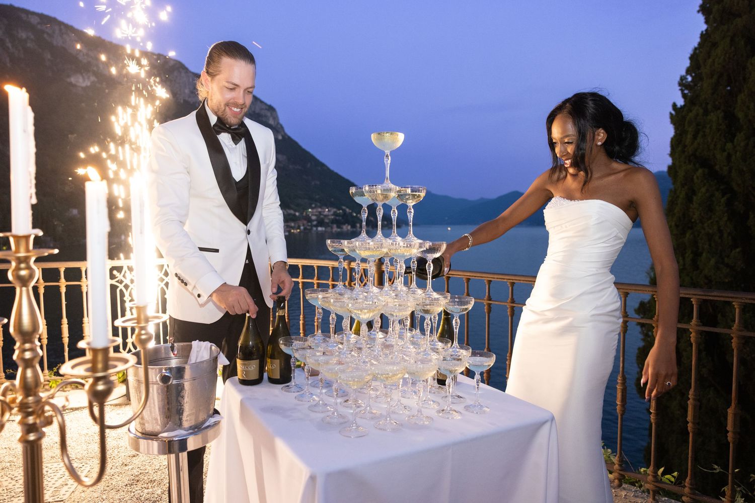 Wedding reception sparklers create magical light trails as newlyweds celebrate with guests on their special evening.