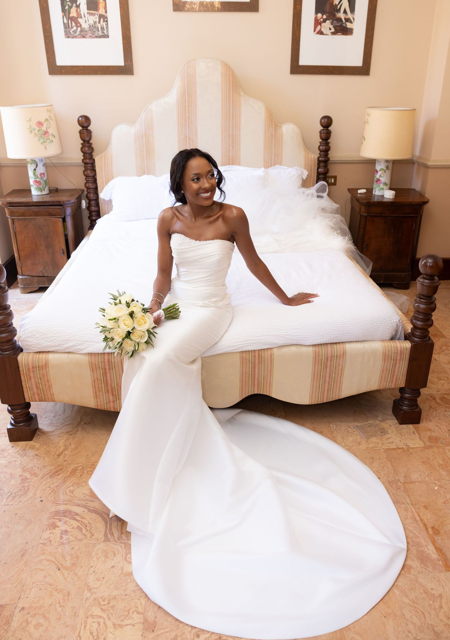 A stunning bride in a flowing white wedding gown twirls gracefully in a sunlit room with vintage furniture.