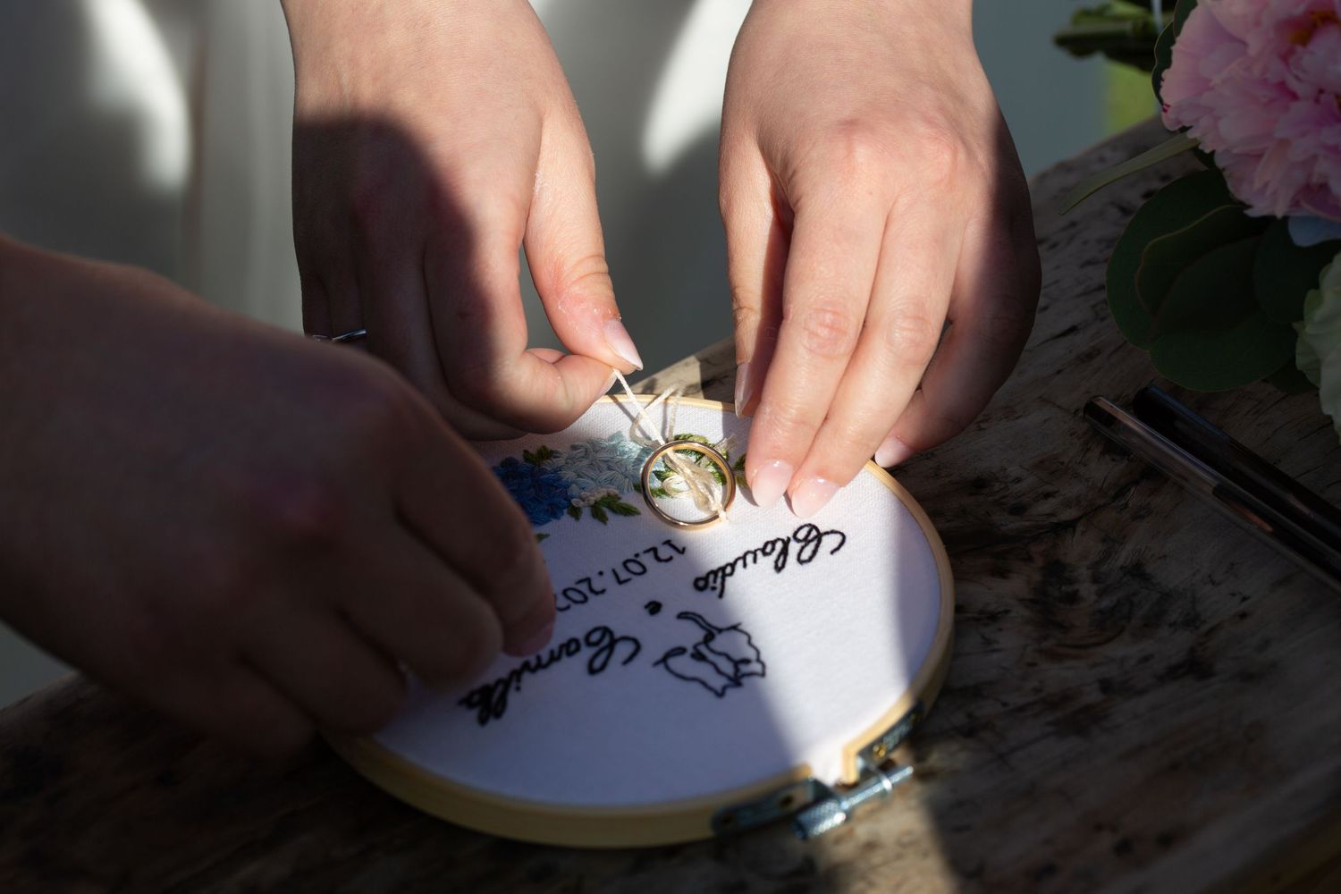 Close-up shots of hands signing wedding documents.