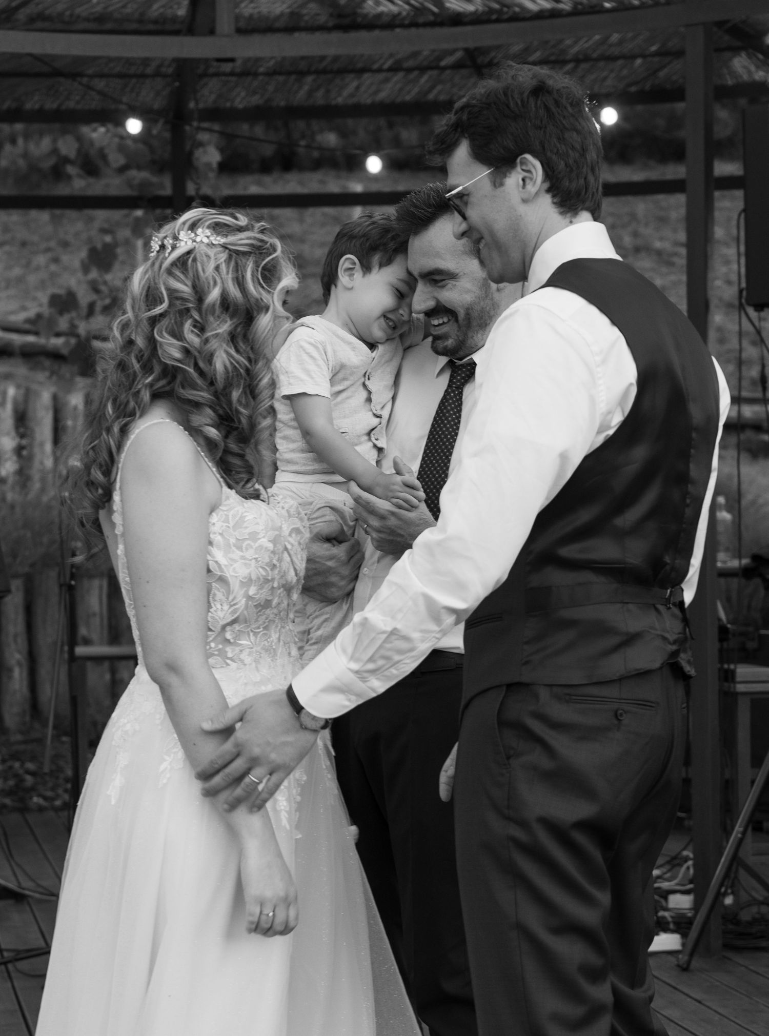 A romantic first dance moment captured in black and white at an indoor reception.