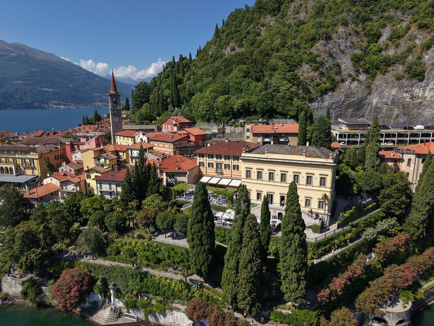 Mediterranean coastal town with terracotta roofs nestled against mountain slopes.