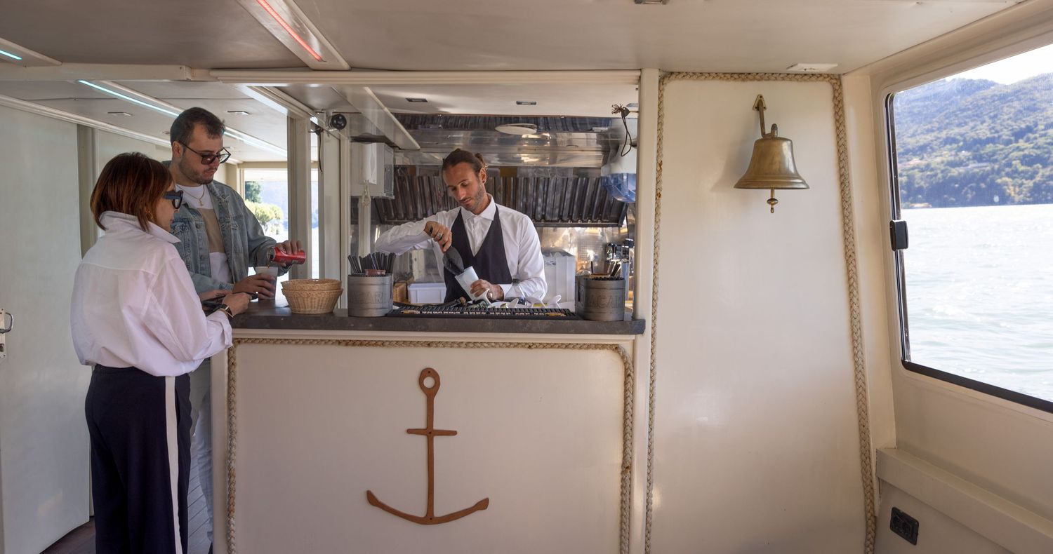 Interior view of a luxury yacht cabin with nautical decor and windows.