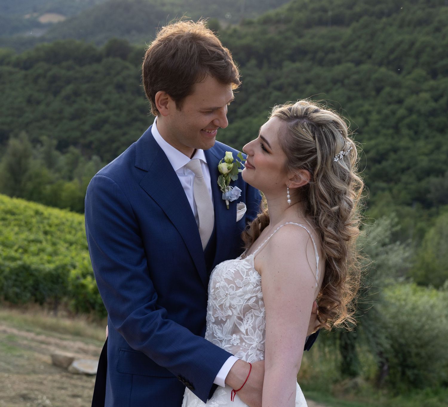 A romantic wedding portrait session in a scenic hillside vineyard.