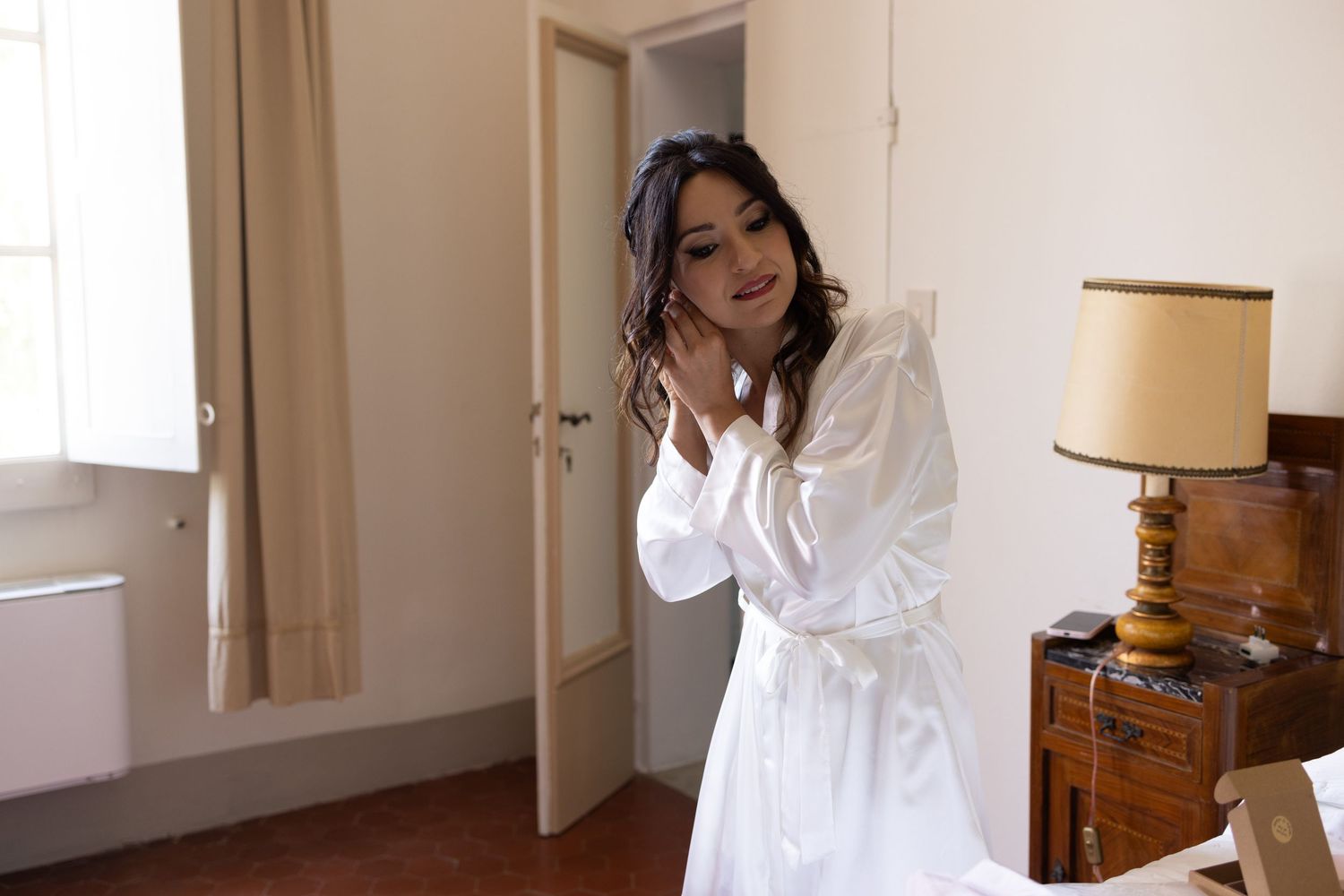 Interior shots of bright hotel room with white decor and natural lighting.