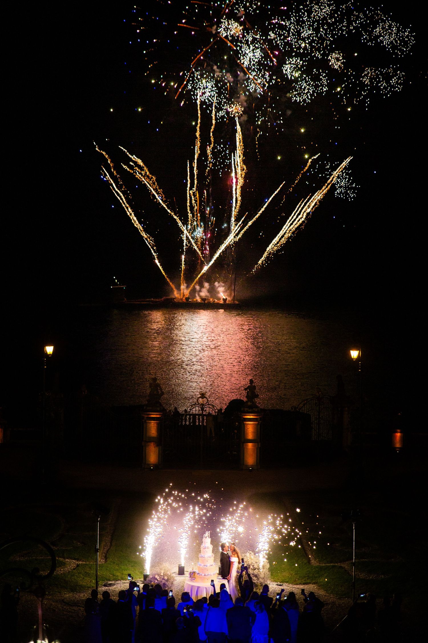 Spectacular fireworks display illuminating the night sky at outdoor wedding celebration.