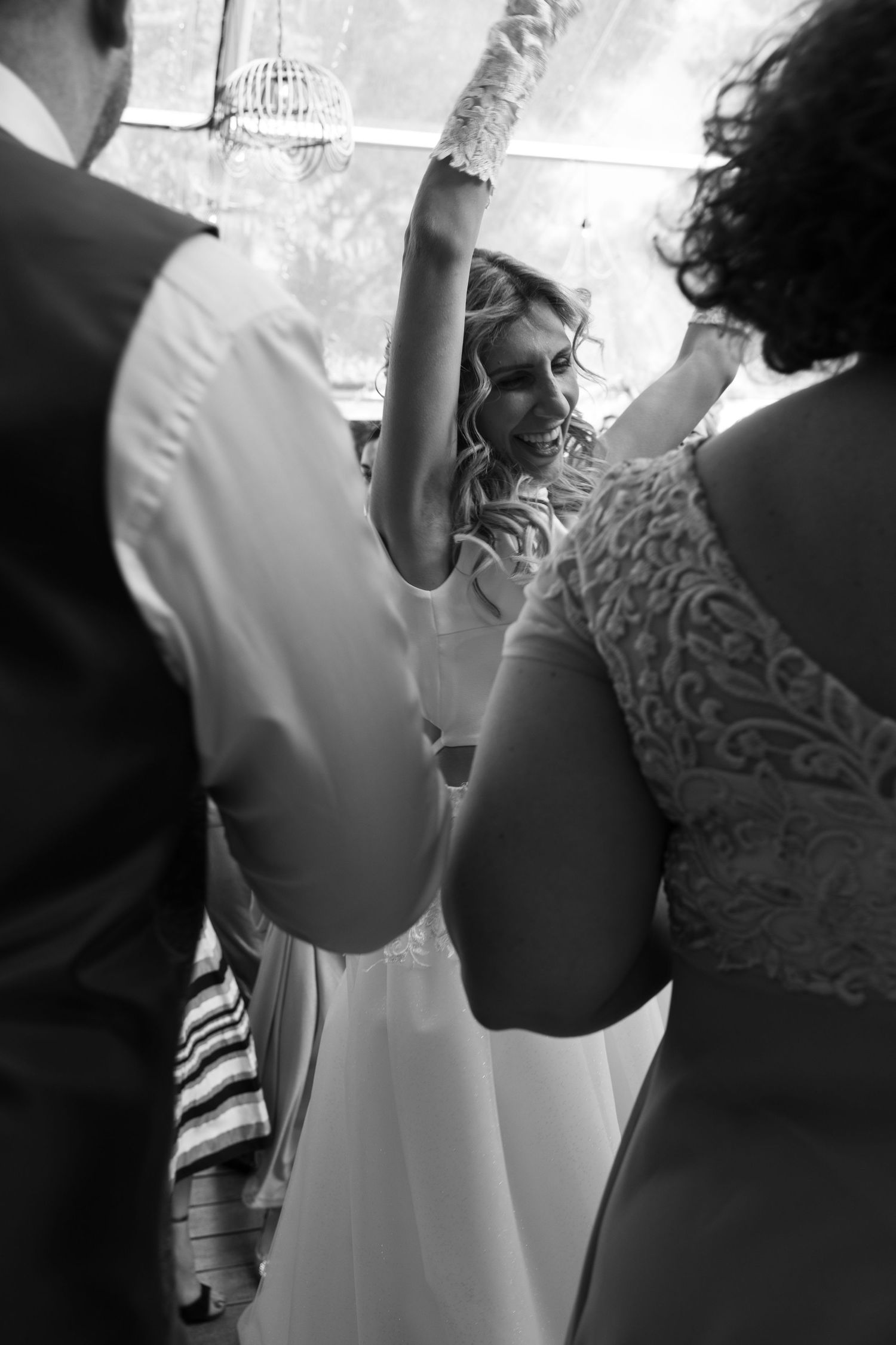 Black and white close-up of wedding dress details and preparations.