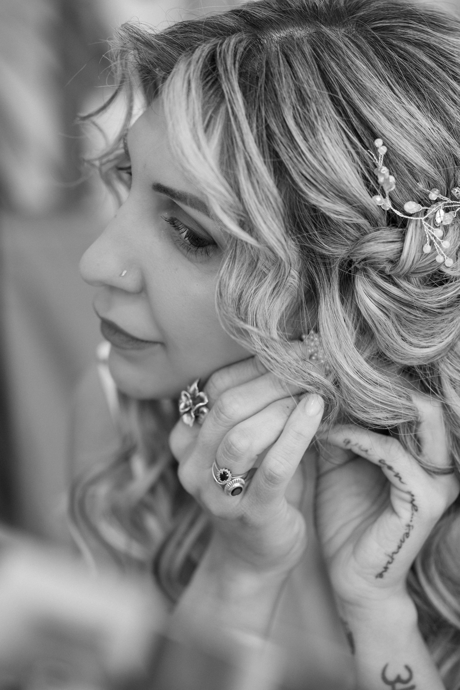 Close-up black and white detail of elegant bridal hair accessories and jewelry.