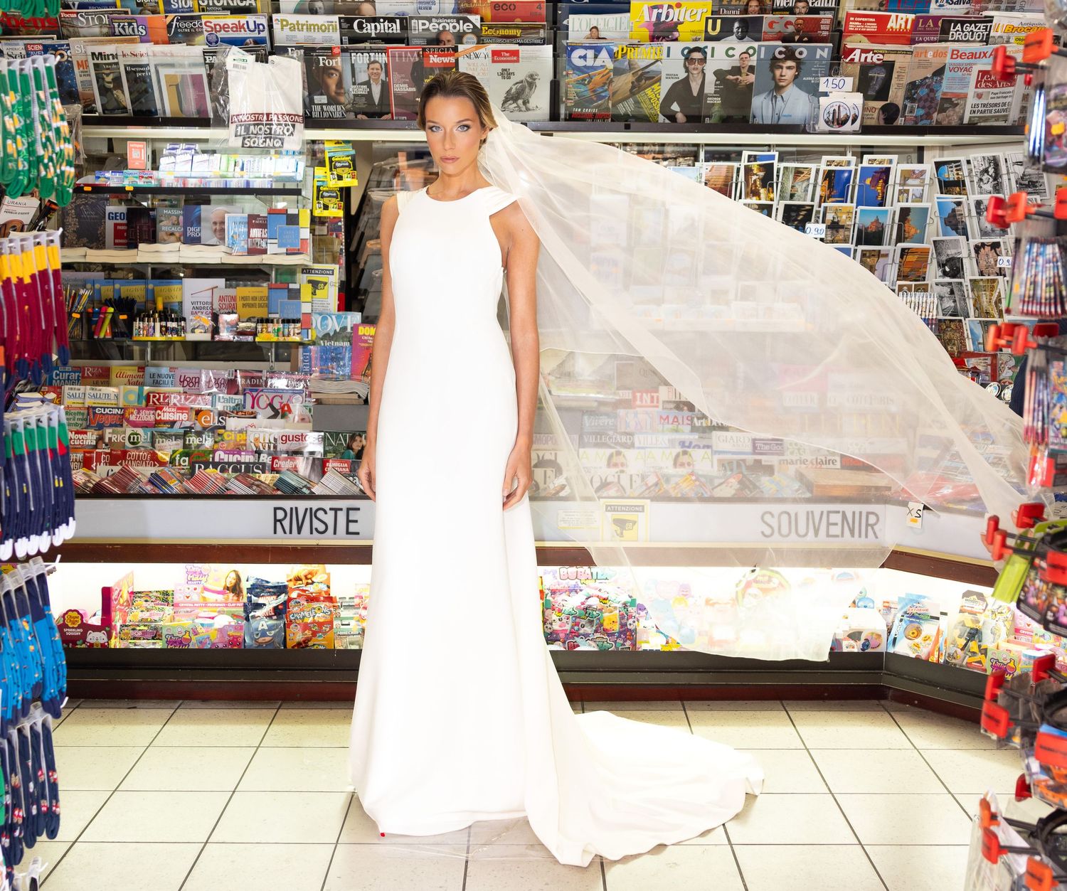 Long view of bridal photography session in Italian convenience store with tiled floor.